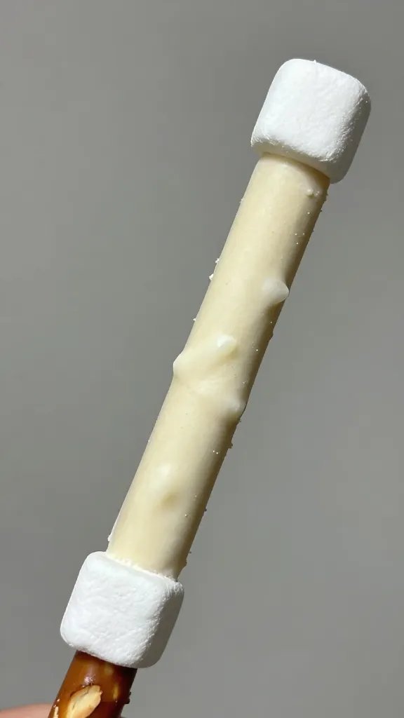 single white chocolate pretzel rod with mini marshmallow “bunny tail”