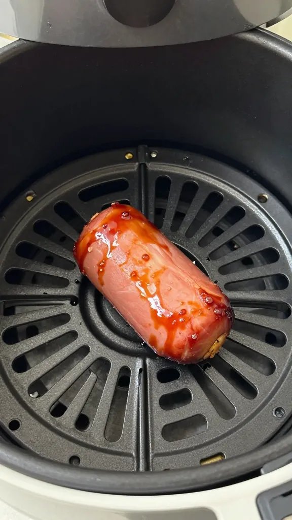 air fryer basket holding one glazed ham bite