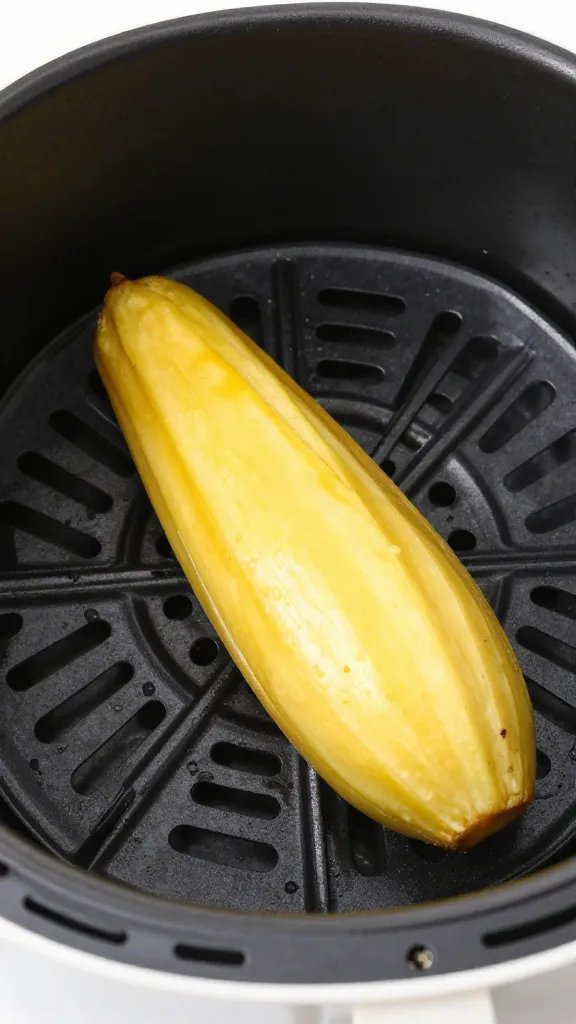 air fryer basket holding one golden chayote wedge