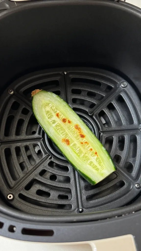 air fryer basket with single crisped cucumber slice