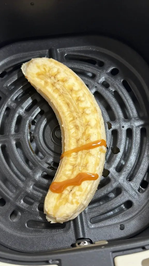 single banana slice on air fryer tray, caramel gloss