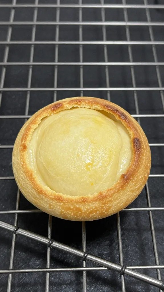 single baked tot on wire rack, crisp edges highlighted