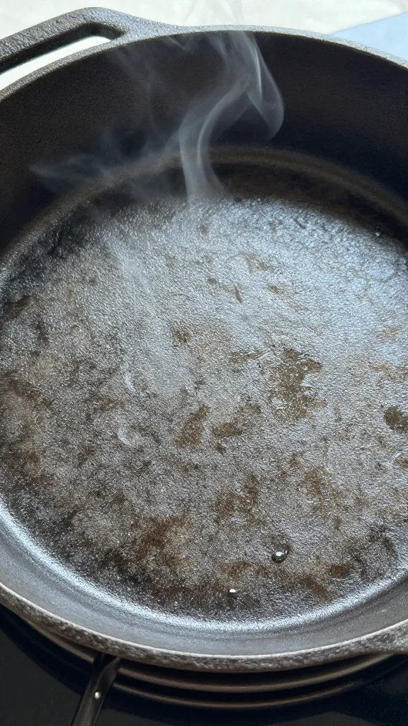 preheated cast-iron pan with parchment, empty and smoking