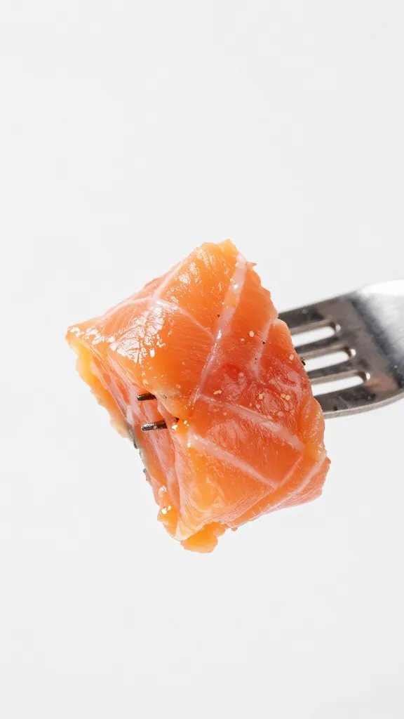 closeup of flaky salmon bite torn with fork action