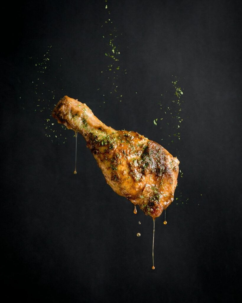 Glistening crispy chicken on a dark background, fresh out of the air fryer